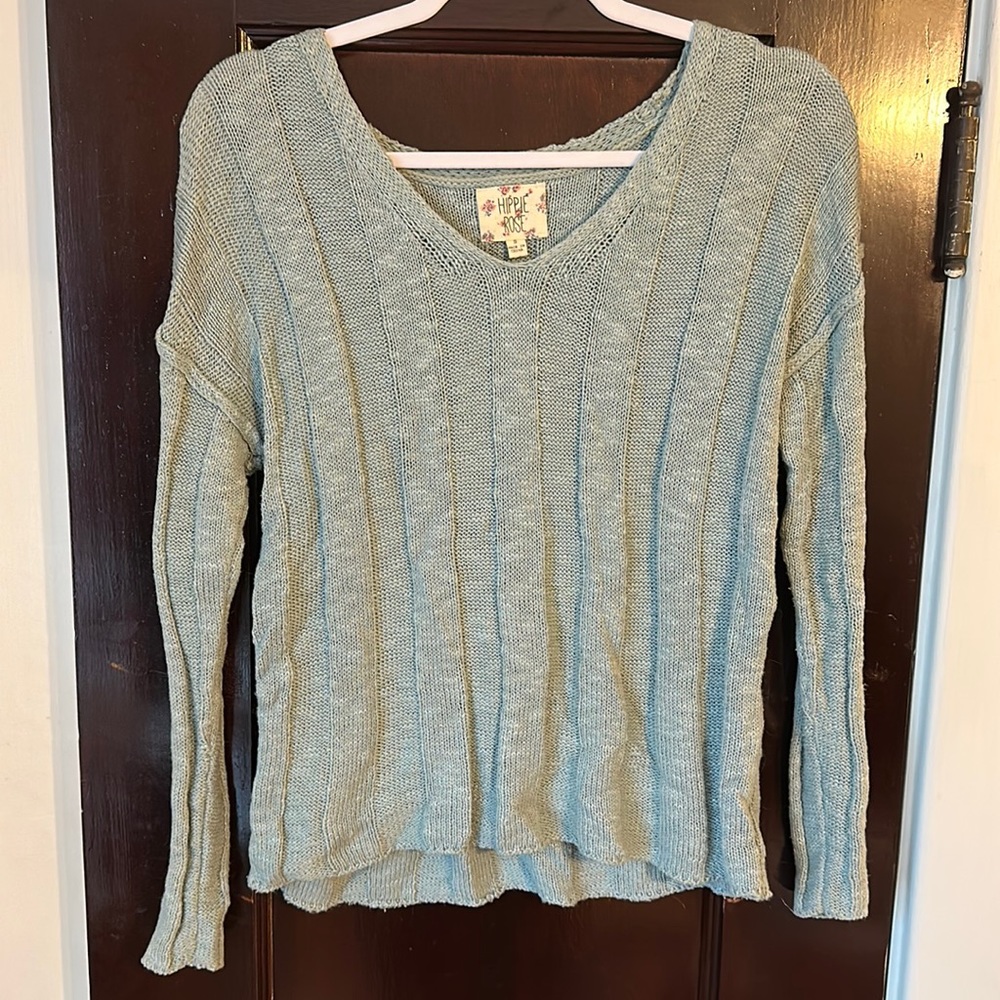 Light blueish green sweater.